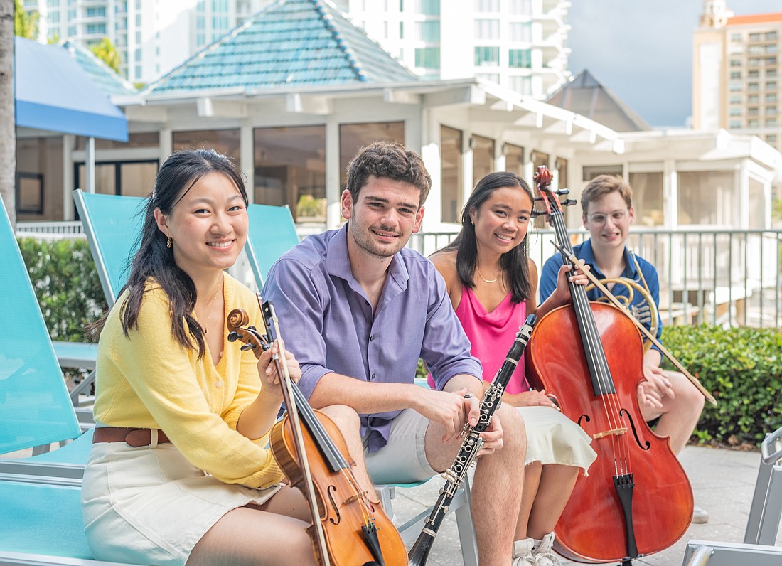 Sarasota Music Festival 2023 fellows Ellen Hayashi, Ray Wyant, Melanie Chen and Daniel Itzkowitz relax with their instruments.